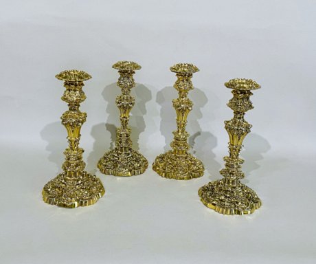 ​A RARE SET OF FOUR GEORGE IV SILVER GILT CANDLESTICKS. FENTON, ALLANSON AND MACHON SHEFFIELD 1824 AND 1826.  - Click to enlarge and for full details.